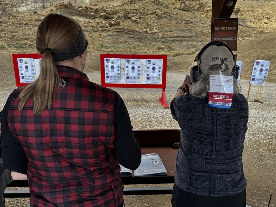 Stephanie Schafer WyoBraska Chapter facilitator running Nancy Keaton through AGAG Pistol Marksmanship Program