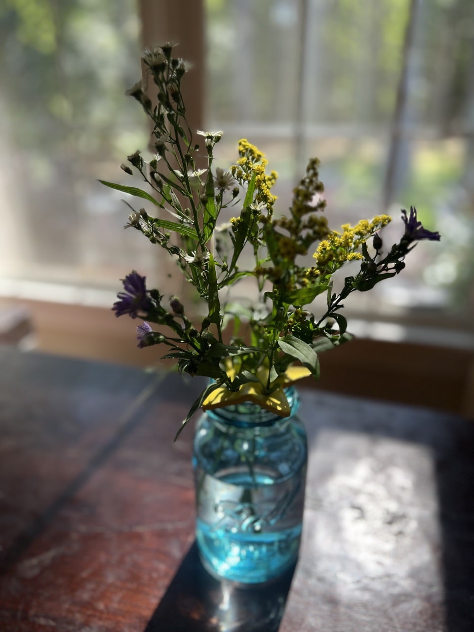 blue ball jar and flowers