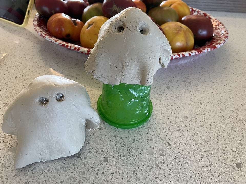 Two air dry clay ghosts on cups