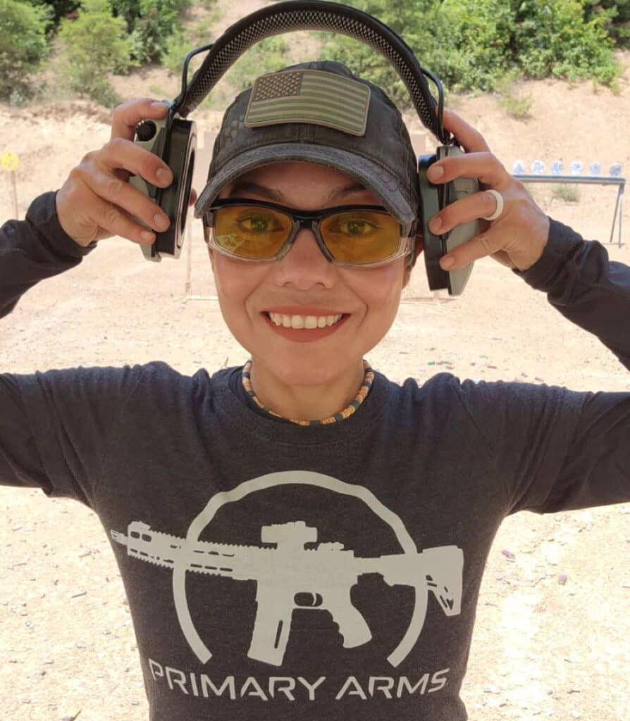 Gabby Franco wearing Primary Arms tshirt and ear protection at the gun range