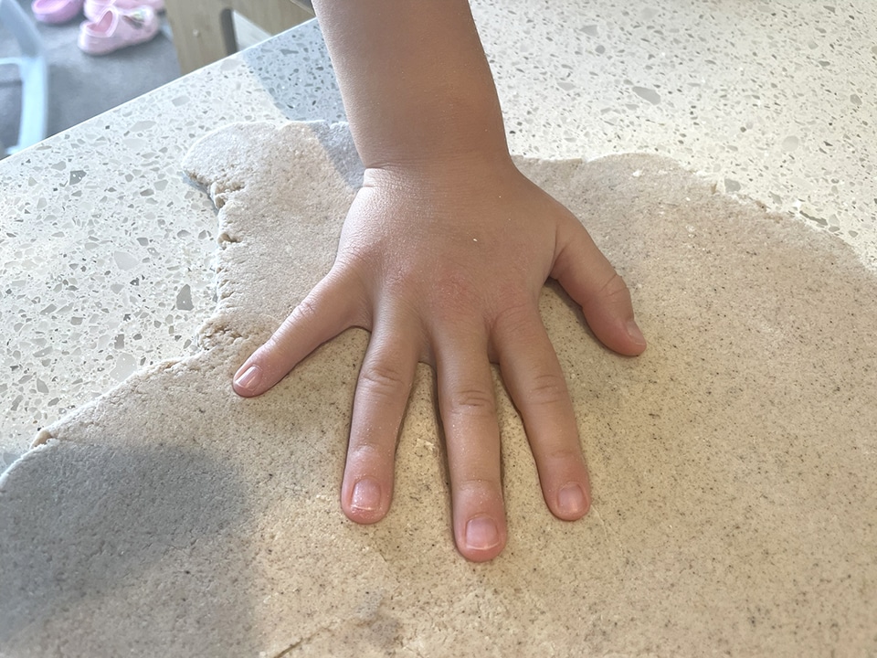 Making handprints in the dough