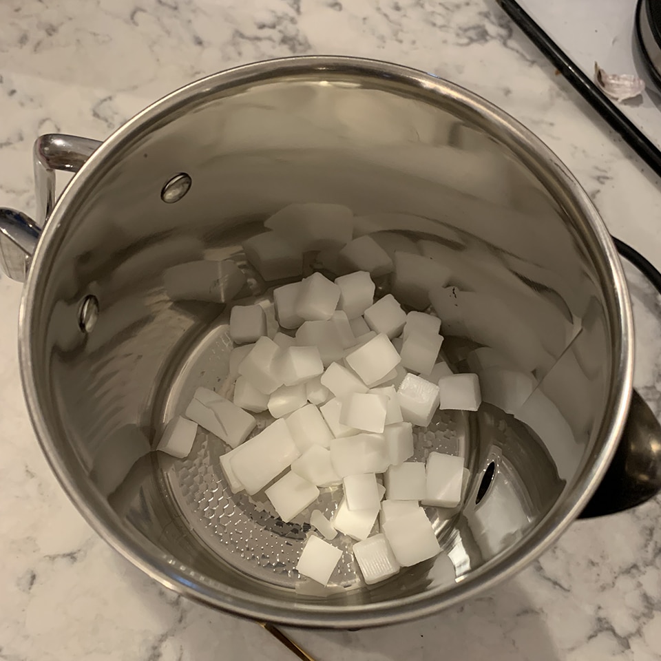 Dropping soap base into pot