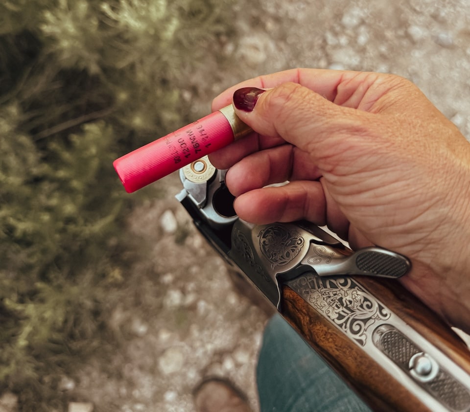 Woman holding Fiocchi shell and  shooting doves