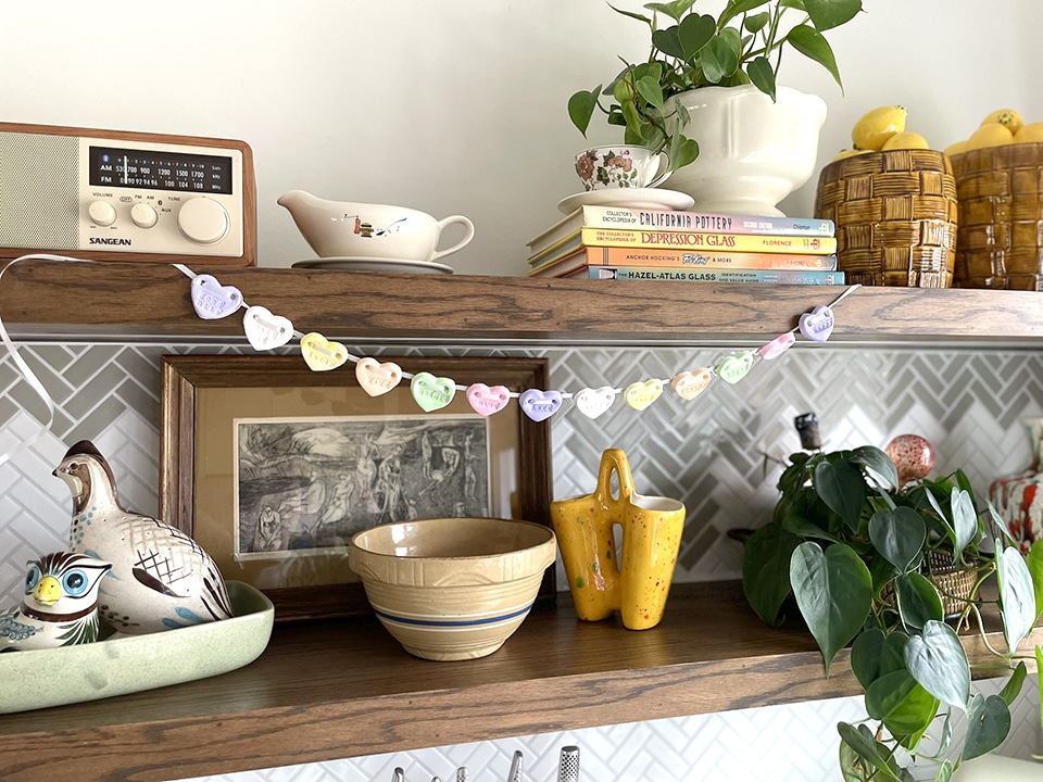 Conversation Heart garland on bookshelf