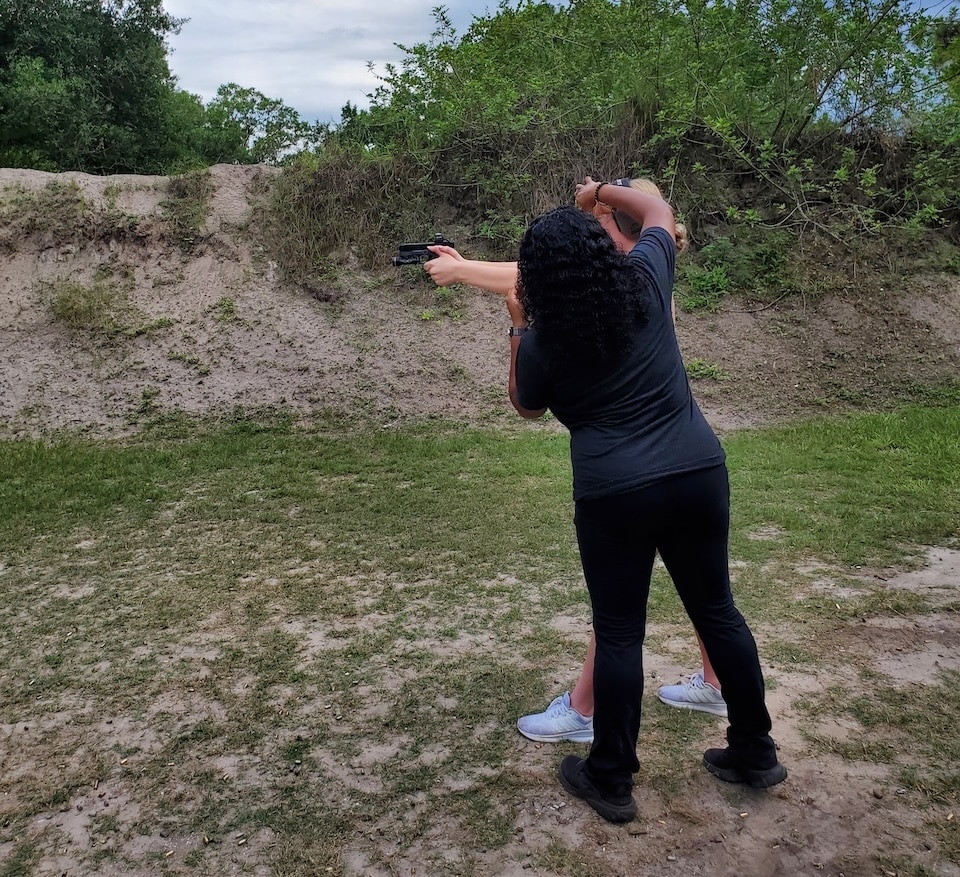 Avery on the range training a female first time shooter